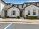 Inviting two-story townhome featuring neat landscaping, gray accents, and covered entry at 193 Captiva Dr, Davenport, FL 33896