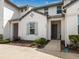 Charming townhome featuring neutral paint, manicured landscaping, and covered entryway at 193 Captiva Dr, Davenport, FL 33896
