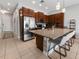 Well-lit kitchen with a large island, stainless steel refrigerator, and ample cabinet space at 193 Captiva Dr, Davenport, FL 33896