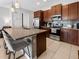 Modern kitchen featuring stainless steel appliances, granite countertops, and stylish pendant lighting at 193 Captiva Dr, Davenport, FL 33896