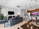 Spacious open-concept living area featuring a kitchen island, modern furnishings, and tile flooring at 193 Captiva Dr, Davenport, FL 33896