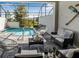 Screened patio with brick pavers, outdoor seating and view of the pool and backyard at 193 Captiva Dr, Davenport, FL 33896