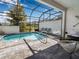 Covered pool with brick pavers, outdoor seating and view of the backyard at 193 Captiva Dr, Davenport, FL 33896