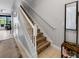 Staircase with whimsical mouse decals and a white railing in a brightly lit hallway at 193 Captiva Dr, Davenport, FL 33896