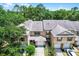 Aerial view of townhomes showcasing manicured lawns, garages, and lush surrounding trees at 207 Sterling Springs Ln, Altamonte Springs, FL 32714