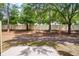 A backyard with a white vinyl fence, mulch, trees and grass at 207 Sterling Springs Ln, Altamonte Springs, FL 32714