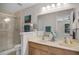Bathroom with a dual-sink vanity, a glass-enclosed shower, and a large mirror at 207 Sterling Springs Ln, Altamonte Springs, FL 32714