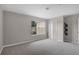 Empty bedroom featuring neutral walls, carpet flooring, and a bright window view at 207 Sterling Springs Ln, Altamonte Springs, FL 32714