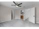 Spacious bedroom with a ceiling fan, neutral paint, and multiple doorways to other rooms at 207 Sterling Springs Ln, Altamonte Springs, FL 32714