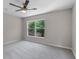 Bedroom with a large window letting in natural light and a modern ceiling fan at 207 Sterling Springs Ln, Altamonte Springs, FL 32714