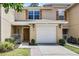Charming townhome featuring a one car garage, wooden shutters and a cozy front porch at 207 Sterling Springs Ln, Altamonte Springs, FL 32714