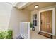 Inviting front porch with stylish welcome mat, a small window and white railing at 207 Sterling Springs Ln, Altamonte Springs, FL 32714