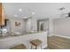 Open concept kitchen with granite countertops and breakfast bar seating, connecting to other rooms at 207 Sterling Springs Ln, Altamonte Springs, FL 32714