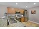 Well-lit kitchen featuring stainless steel appliances, tile flooring and granite countertops at 207 Sterling Springs Ln, Altamonte Springs, FL 32714