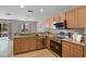 Modern kitchen overlooking the living room with granite countertops and stainless steel appliances at 207 Sterling Springs Ln, Altamonte Springs, FL 32714