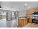 Modern kitchen overlooking the living room with granite countertops and stainless steel appliances at 207 Sterling Springs Ln, Altamonte Springs, FL 32714