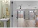View from bathroom into open-concept living room featuring neutral walls and tile floors at 207 Sterling Springs Ln, Altamonte Springs, FL 32714