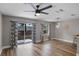 Open living room with a ceiling fan, pendant light, and sliding doors leading to the backyard at 207 Sterling Springs Ln, Altamonte Springs, FL 32714