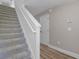Carpeted staircase featuring white risers and a white railing at 207 Sterling Springs Ln, Altamonte Springs, FL 32714