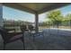 Covered back patio featuring wicker furniture, a coffee table, and views of the pool at 2168 Marsh Sedge Ln, Winter Park, FL 32792