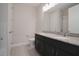 Bathroom features a double sink vanity with granite countertops and tiled floors at 2168 Marsh Sedge Ln, Winter Park, FL 32792