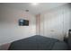 Cozy bedroom featuring a mounted TV and double door closet space at 2168 Marsh Sedge Ln, Winter Park, FL 32792
