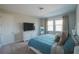 Relaxing bedroom featuring bright windows, soft carpets, and stylish decor perfect for a great sleep at 2168 Marsh Sedge Ln, Winter Park, FL 32792