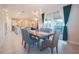 Bright dining area featuring a modern light fixture and sliding glass doors to the outdoor space at 2168 Marsh Sedge Ln, Winter Park, FL 32792
