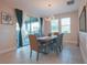 The Dining Room is complete with modern lighting, a view of the back yard, and seating for six at 2168 Marsh Sedge Ln, Winter Park, FL 32792