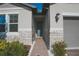 Inviting entryway with stone accents and a charming blue front door with sidelight at 2168 Marsh Sedge Ln, Winter Park, FL 32792