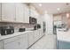 Contemporary kitchen with white cabinetry, stainless steel appliances, and sleek countertops at 2168 Marsh Sedge Ln, Winter Park, FL 32792