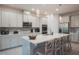 Bright kitchen featuring white cabinets, quartz countertops, and a center island with seating at 2168 Marsh Sedge Ln, Winter Park, FL 32792