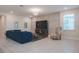 Comfortable living room featuring a cozy blue sofa, contemporary lighting, and neutral decor at 2168 Marsh Sedge Ln, Winter Park, FL 32792