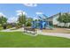 Community playground featuring slides, climbing structures, and benches at 2168 Marsh Sedge Ln, Winter Park, FL 32792