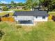 Aerial view of backyard featuring patio, new roof, well kept lawn, and fencing at 2412 Yule Tree Dr, Edgewater, FL 32141