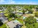 An aerial view showcasing the property nestled in a tranquil neighborhood with mature trees and green lawns at 2412 Yule Tree Dr, Edgewater, FL 32141