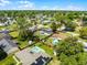 Aerial view of home with pool in fenced yard, outlined in red, nestled in a lush, green neighborhood at 2412 Yule Tree Dr, Edgewater, FL 32141