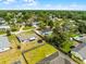 Aerial view of a home with a fenced yard outlined in red, showcasing its positioning within a verdant neighborhood at 2412 Yule Tree Dr, Edgewater, FL 32141