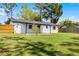 Expansive backyard boasts lush green grass and a charming white home exterior at 2412 Yule Tree Dr, Edgewater, FL 32141