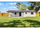 Spacious backyard with a well-maintained lawn and a quaint white house at 2412 Yule Tree Dr, Edgewater, FL 32141