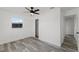 Bedroom showcases gray flooring, ceiling fan, closet, and bright window at 2412 Yule Tree Dr, Edgewater, FL 32141
