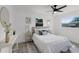 Bright bedroom with wood floors, white walls, and plush white bedding at 2412 Yule Tree Dr, Edgewater, FL 32141