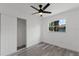 Bedroom features stylish gray flooring, ceiling fan, closet, and natural light from the window at 2412 Yule Tree Dr, Edgewater, FL 32141