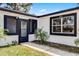Charming front entrance with well-maintained landscaping and an inviting walkway, enhancing curb appeal at 2412 Yule Tree Dr, Edgewater, FL 32141