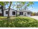 Inviting single story home featuring lush landscaping and a well-maintained exterior at 2412 Yule Tree Dr, Edgewater, FL 32141