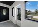 Welcoming front porch with a sleek black door and storm door, offering an inviting entrance to the home at 2412 Yule Tree Dr, Edgewater, FL 32141