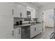 Modern kitchen featuring white cabinets, stainless steel appliances, and gray countertops at 2412 Yule Tree Dr, Edgewater, FL 32141