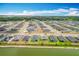 Expansive aerial view of the neighborhood showcasing the homes, streets, and adjacent pond at 284 Talladega Ln, Polk City, FL 33868