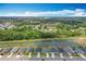 Aerial shot featuring a serene pond and the layout of homes in the surrounding neighborhood at 284 Talladega Ln, Polk City, FL 33868