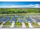 Neighborhood aerial view showcasing homes near a tranquil pond and lush green trees at 284 Talladega Ln, Polk City, FL 33868